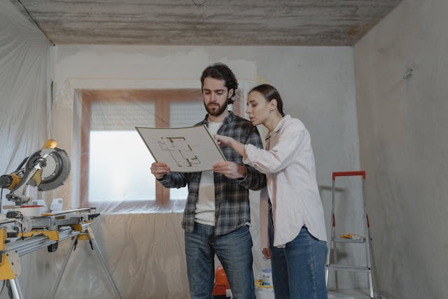 A man talking with a woman and looking at a piece of paper 